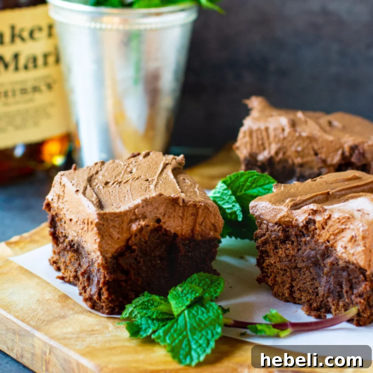 Kentucky Mint Chocolate Brownies 2 Mint Julep Brownies artfully arranged on a cutting board with vibrant fresh mint garnishes, ready to be served for Derby Day.