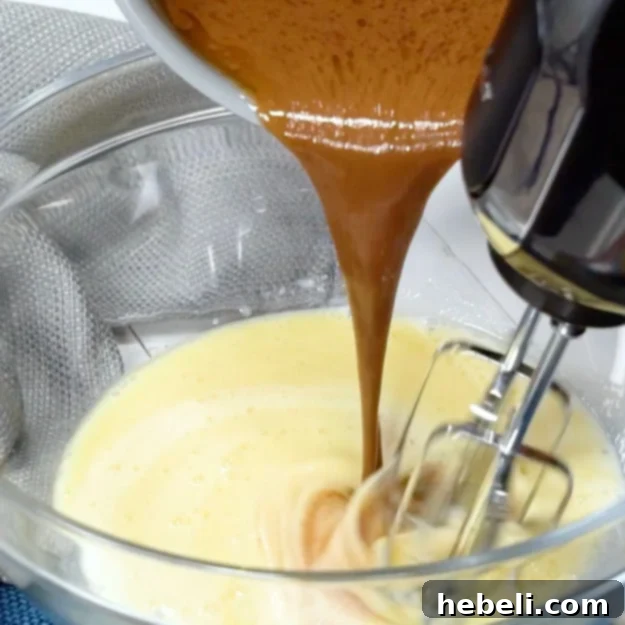 Velvety Chocolate Buttermilk Indulgence 5 The melted butter and cocoa mixture being gradually added to the buttermilk and egg batter, creating a smooth cake base.