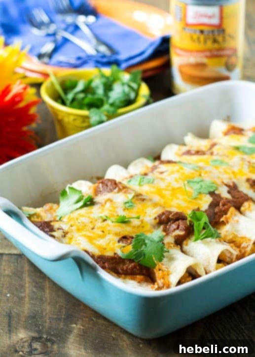 Smoky Ancho Pumpkin Pulled Pork Enchiladas 3 Close-up of Pumpkin-Ancho Enchiladas with Pulled Pork, showing vibrant colors and cheese topping