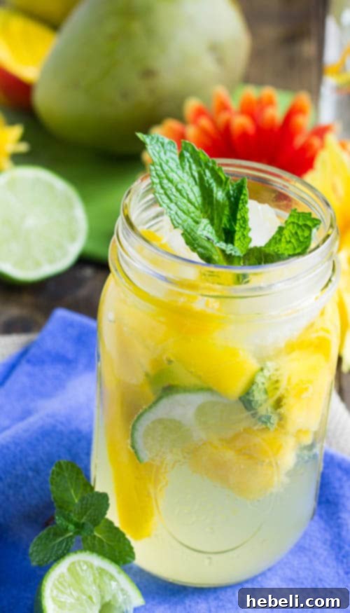 Tropical Mango Mojito 3 Close-up of Mango Mojito ingredients being muddled in a glass