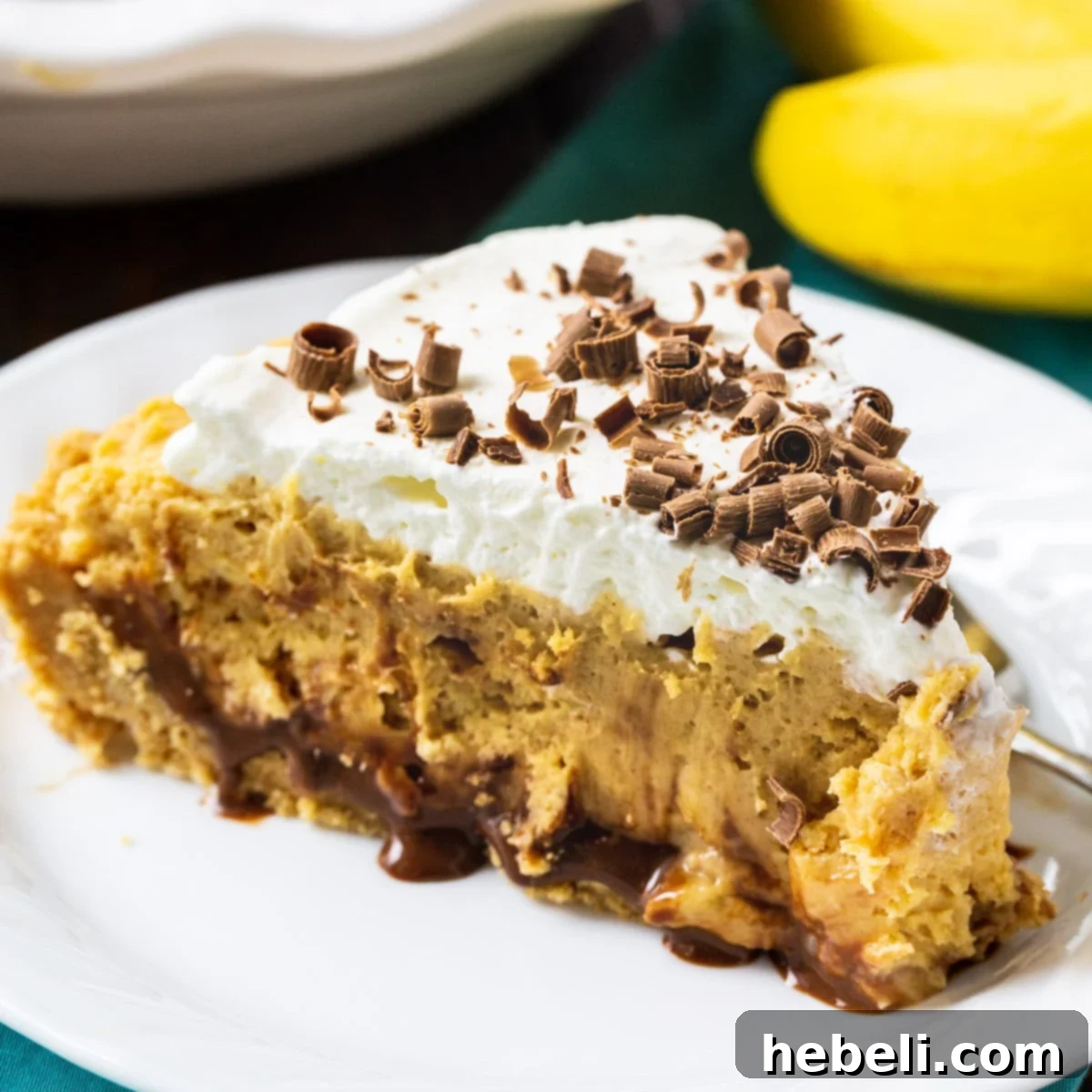 Slice of Creamy Peanut Butter Banana Pie on a plate, showcasing its distinct layers.