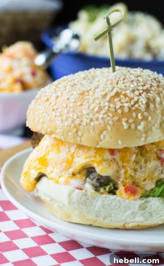 A vibrant Pimento Cheese Burger presented on a dark plate, emphasizing its rich texture and color. #recipe #southern