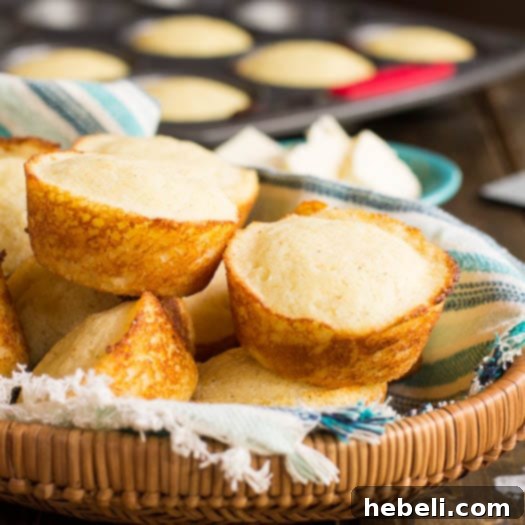 Tangy Golden Cornbread Muffins 5 Stacked Buttermilk Cornbread Muffins, showcasing their golden texture.