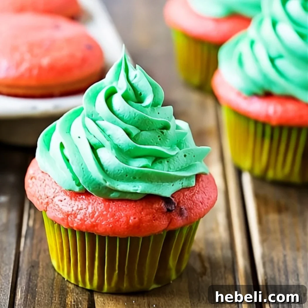 Vibrant Watermelon Mojito cupcakes beautifully arranged on a rustic picnic table, ready to be enjoyed at a summer party or Fourth of July celebration.