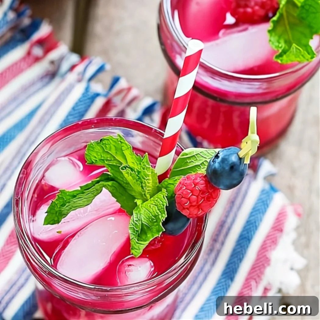 Two glasses of Berry Mojitos with fresh mint and berries