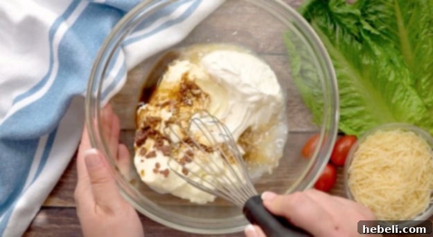 Hearty Chicken Caesar Pasta Salad 2 Mixing the homemade Caesar dressing in a small bowl with a whisk