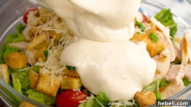 Hearty Chicken Caesar Pasta Salad 5 Tossing the remaining Caesar dressing into the fully combined pasta salad with all ingredients