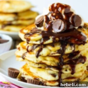 A stack of perfectly cooked Peanut Butter Cup Pancakes, ready to be adorned with toppings.