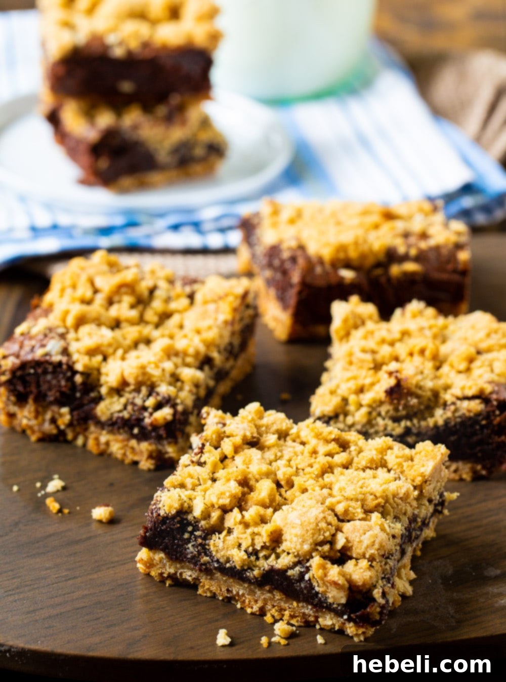 Decadent Chocolate Fudge Oat Bars 3 Close-up of freshly baked Chocolate Oatmeal Bars on a wooden surface, highlighting their rich texture and golden crust.