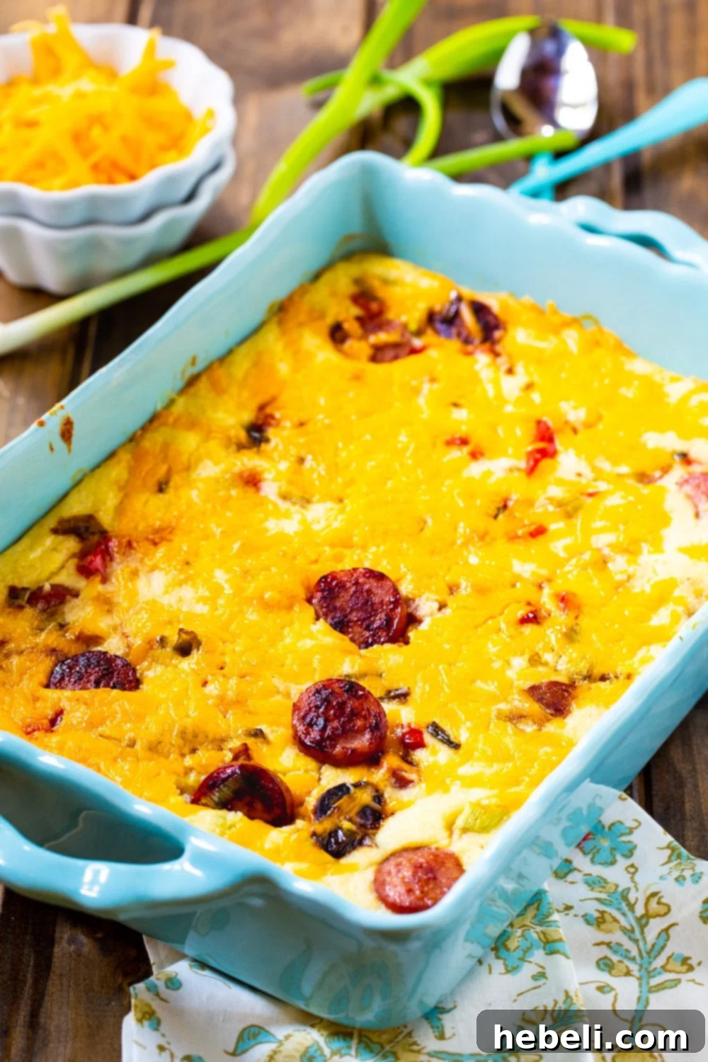 Cheesy Grits Casserole in a deep blue baking dish, garnished with fresh parsley.