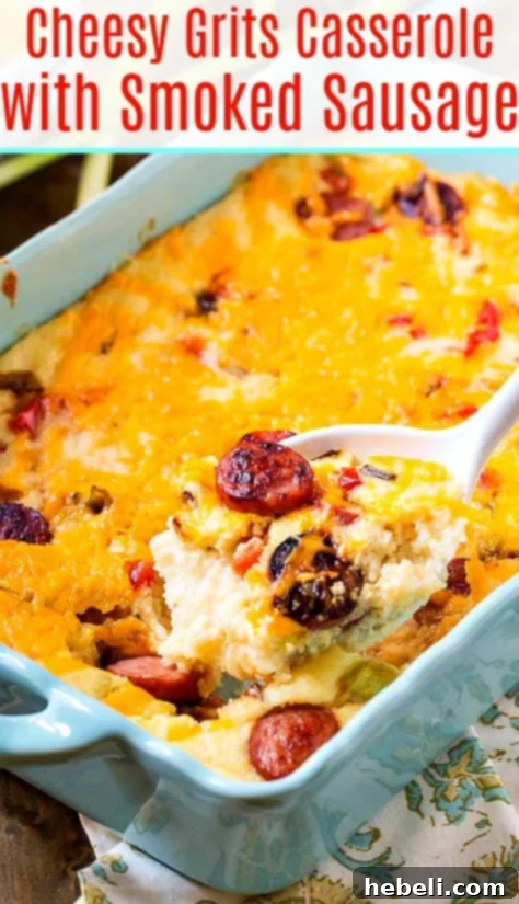 Overhead shot of a full Cheesy Grits Casserole with Smoked Sausage in a rectangular baking dish, ready to be sliced.