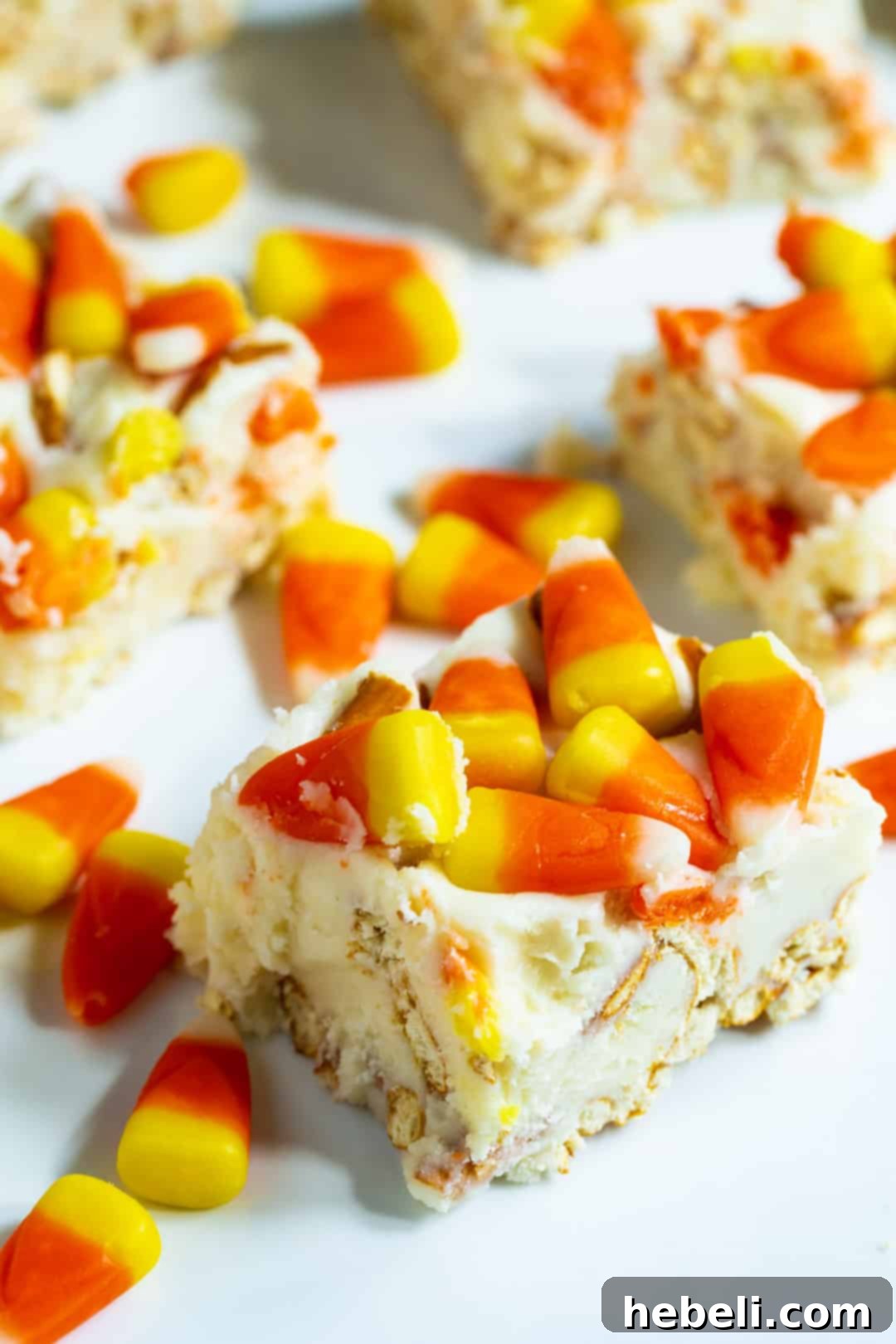 Perfectly cut squares of creamy fudge on a white background, ready for serving.