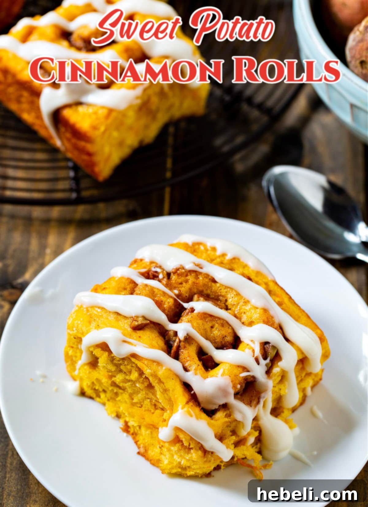Another close-up of a sweet potato cinnamon roll on a plate, highlighting the rich texture and delicious glaze.