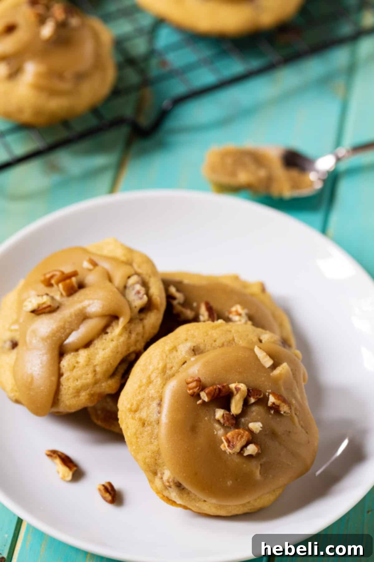 Three decadent Caramel Frosted Brown Sugar Cookies arranged on a serving plate.