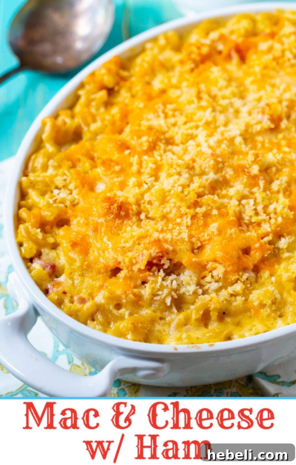 Golden Baked Ham Macaroni 3 Creamy Mac and Cheese with Ham served in an elegant oval baking dish, ready to be enjoyed.