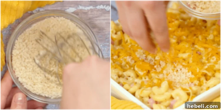 Golden Baked Ham Macaroni 7 Close-up image of panko topping being sprinkled over the assembled Mac and Cheese with Ham in a baking dish.