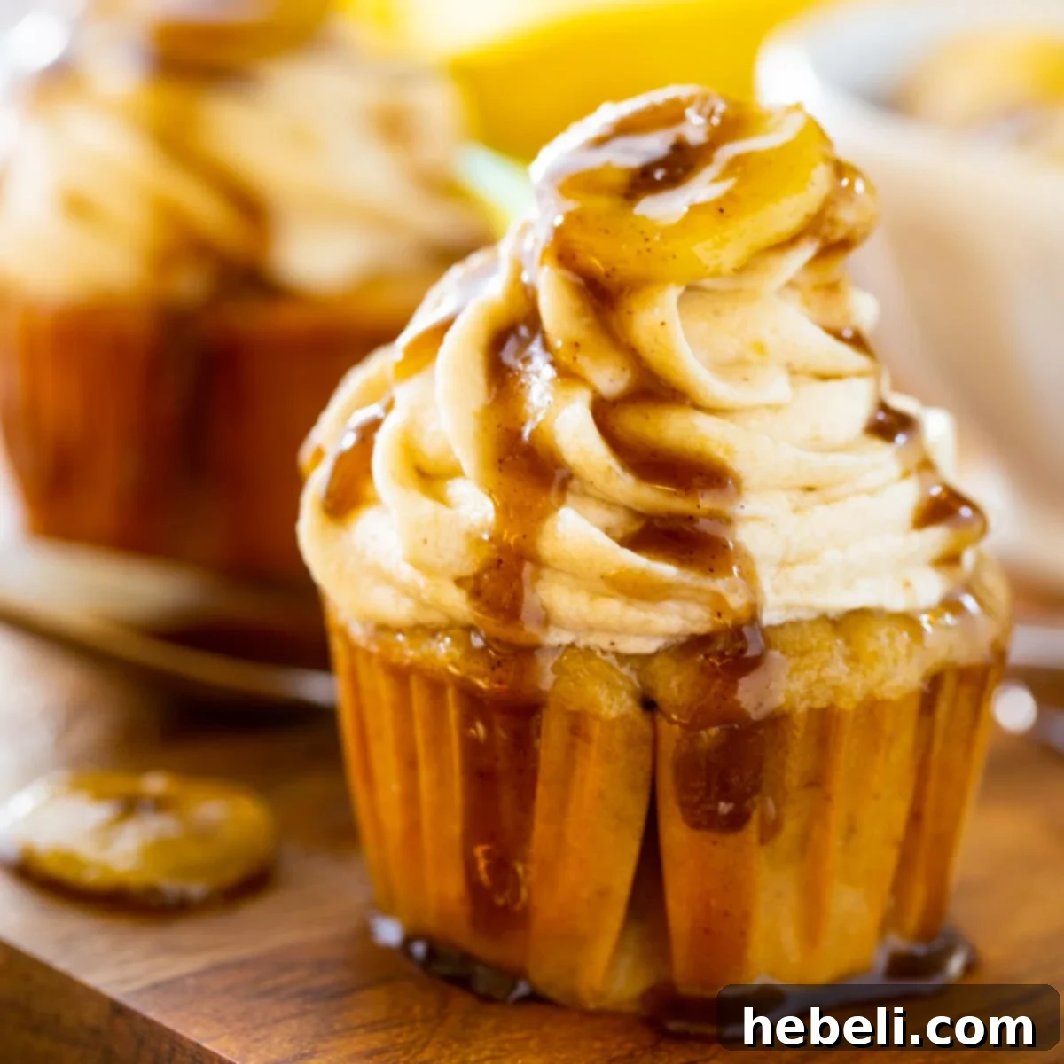 Decadent Bananas Foster Cupcakes 2 Bananas Foster Cupcake on a wooden board.