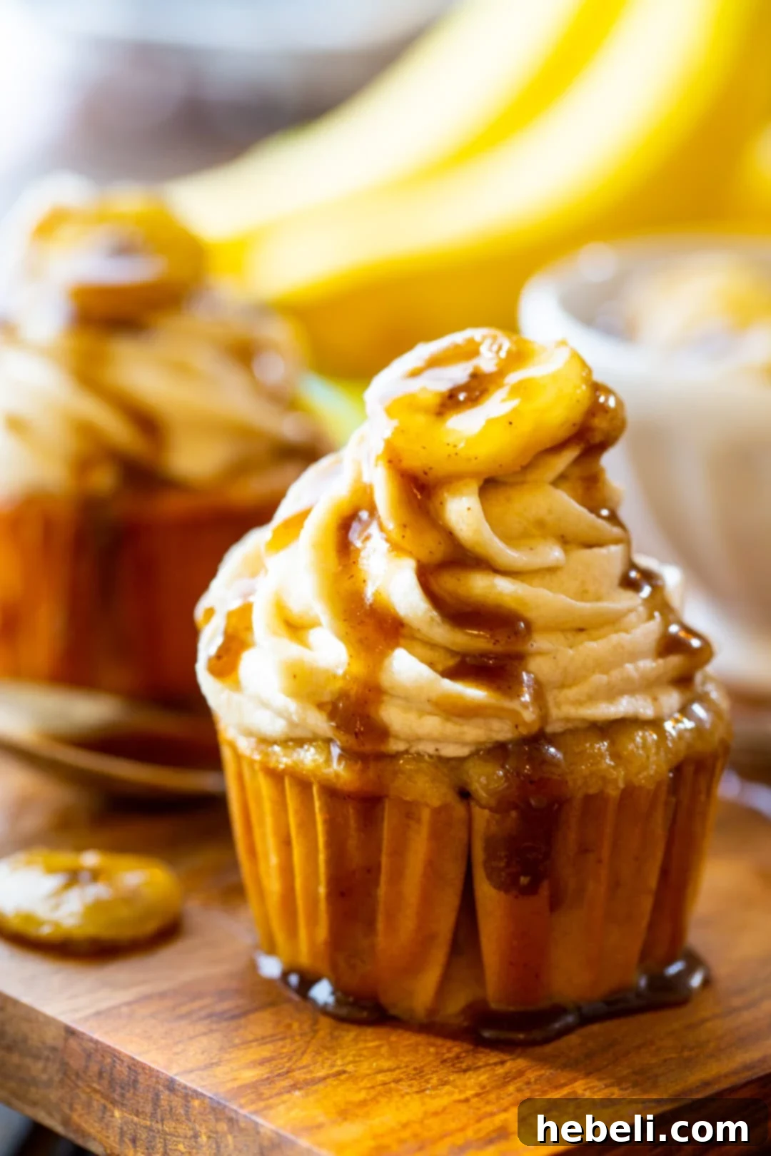 Decadent Bananas Foster Cupcakes 3 Bananas Foster Cupcakes with praline sauce dripping down.