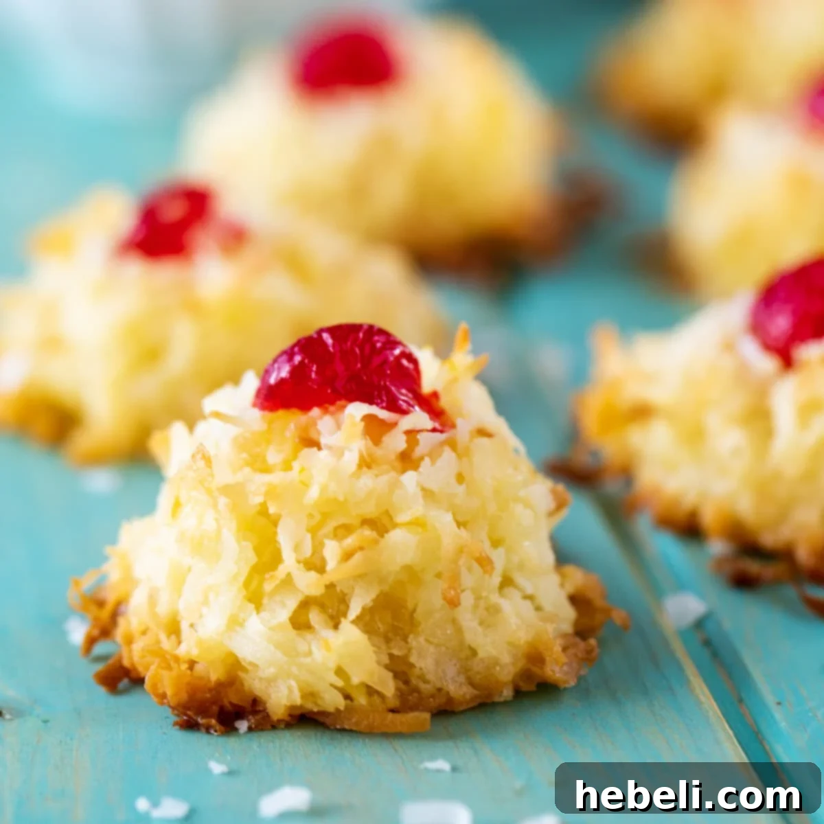 Ambrosia Macaroons topped with cherry halves, ready for a holiday platter.