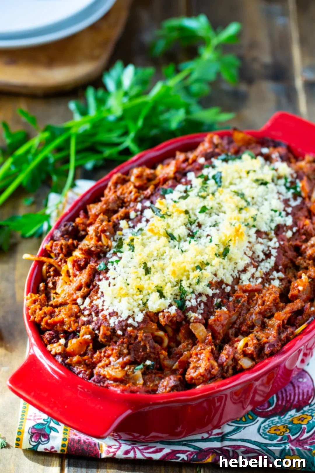 Creamy Spaghetti Casserole bake in a vibrant red casserole dish, ready to be served.