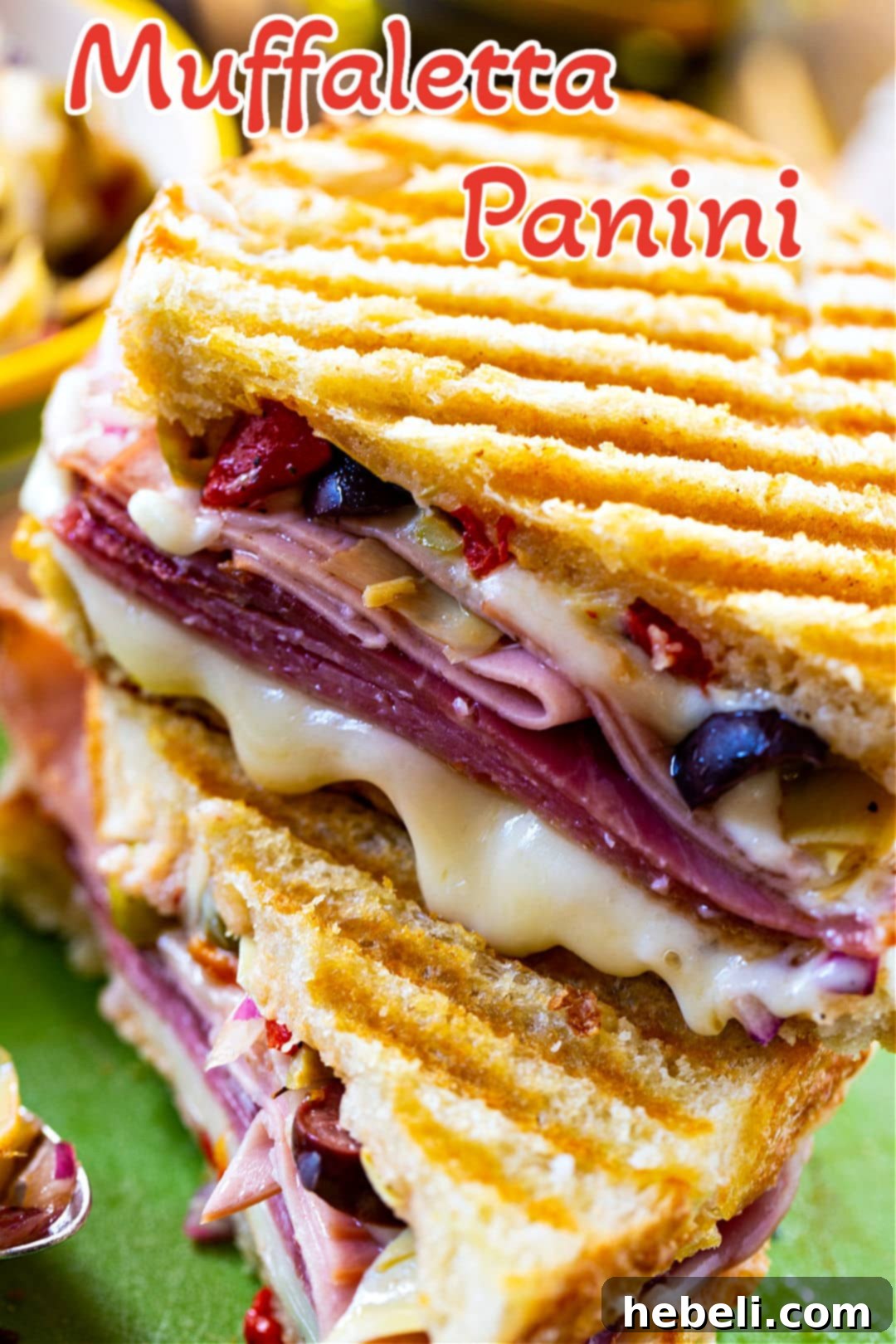 Up-close of panini cut in half, revealing the layers and crispy texture.