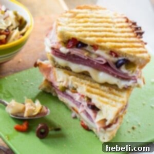 Hot Pressed Muffaletta Panini 6 Muffaletta Panini with 3 kinds of meat, provolone cheese, and olive relish.