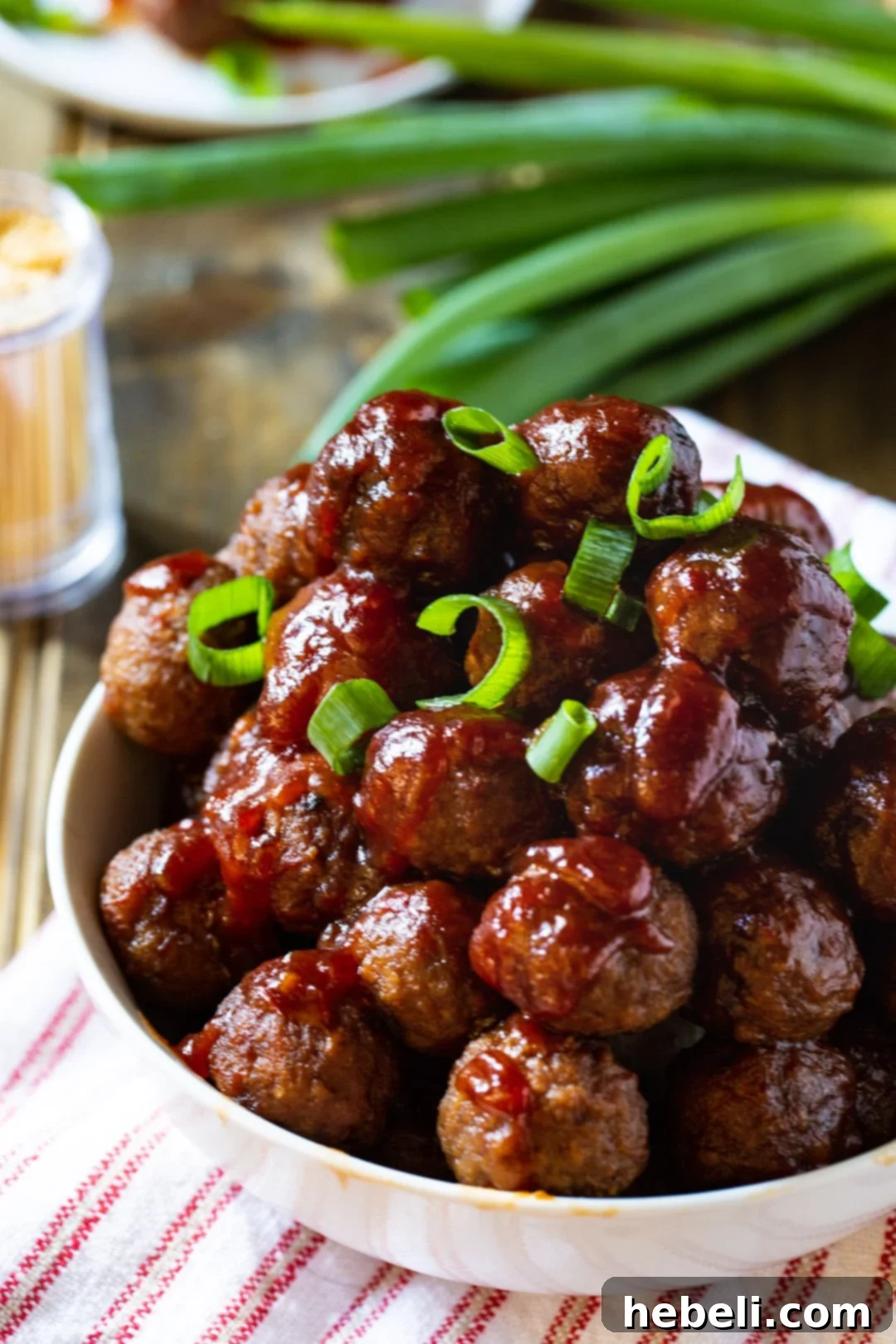 Close-up of succulent Cranberry Meatballs coated in a rich, glossy sauce, ready to be served.