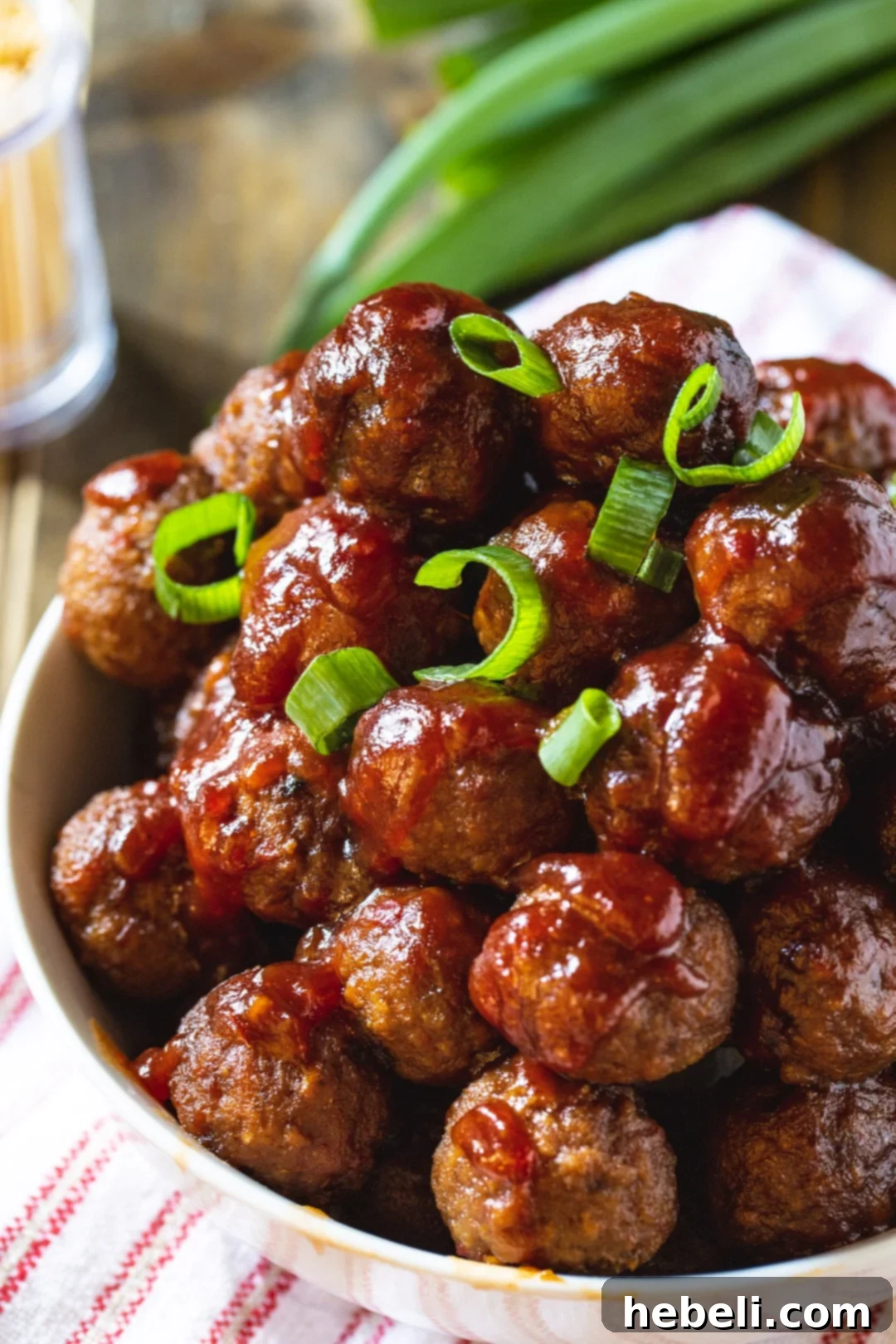 A bowl of delicious Cranberry Meatballs, garnished with fresh herbs, showcasing their festive appeal.
