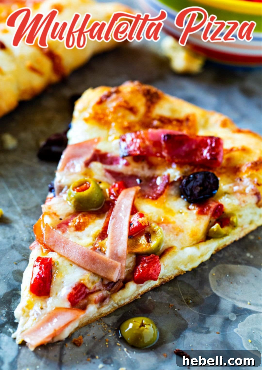 New Orleans Muffaletta Pizza 5 A beautifully presented whole Muffaletta Pizza, expertly sliced and ready to be served, highlighting its rich textures and vibrant colors.