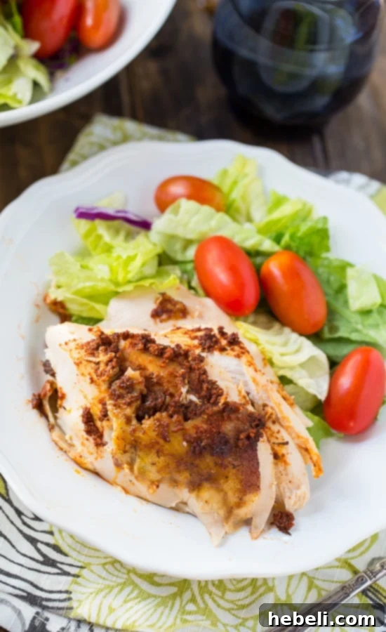 Slow Cooker Spiced Whole Chicken nestled on a bed of sliced onions, promising tender, juicy results. #crockpot #wholechicken