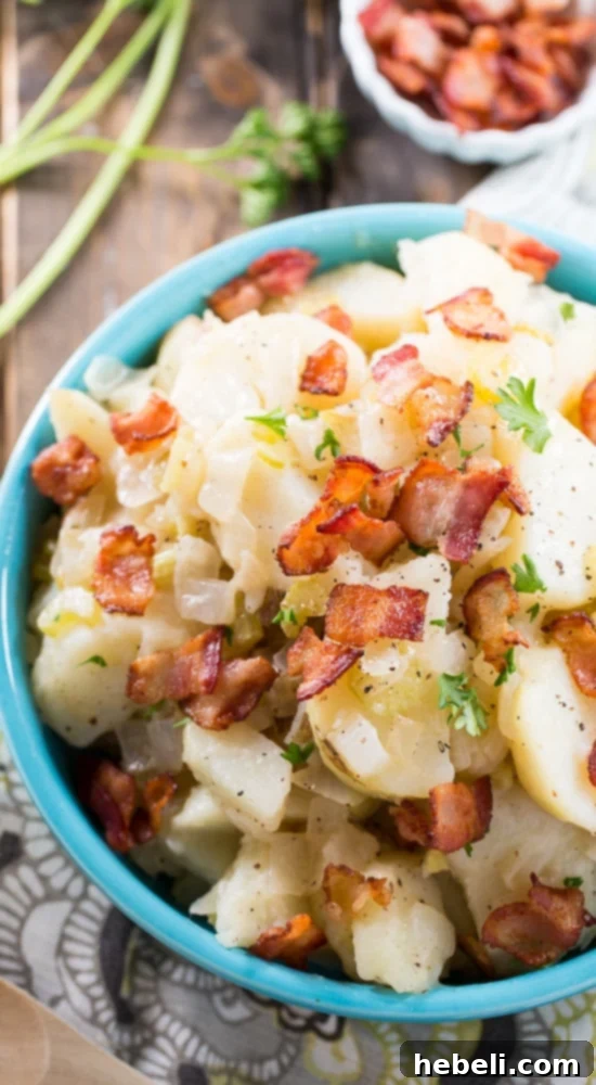 Hot Potato Salad, generously garnished with crispy bacon bits, is a must-try savory recipe. Perfectly seasoned and satisfying. #SplendaSweeties #SweetSwaps #savoryrecipe