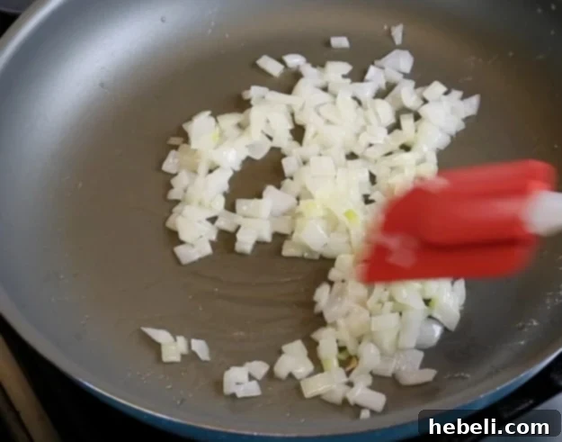 Fiery Black-Eyed Pea Delight 5 Cooking diced onion in butter until soft and translucent, the first step in preparing the black-eyed pea dip.