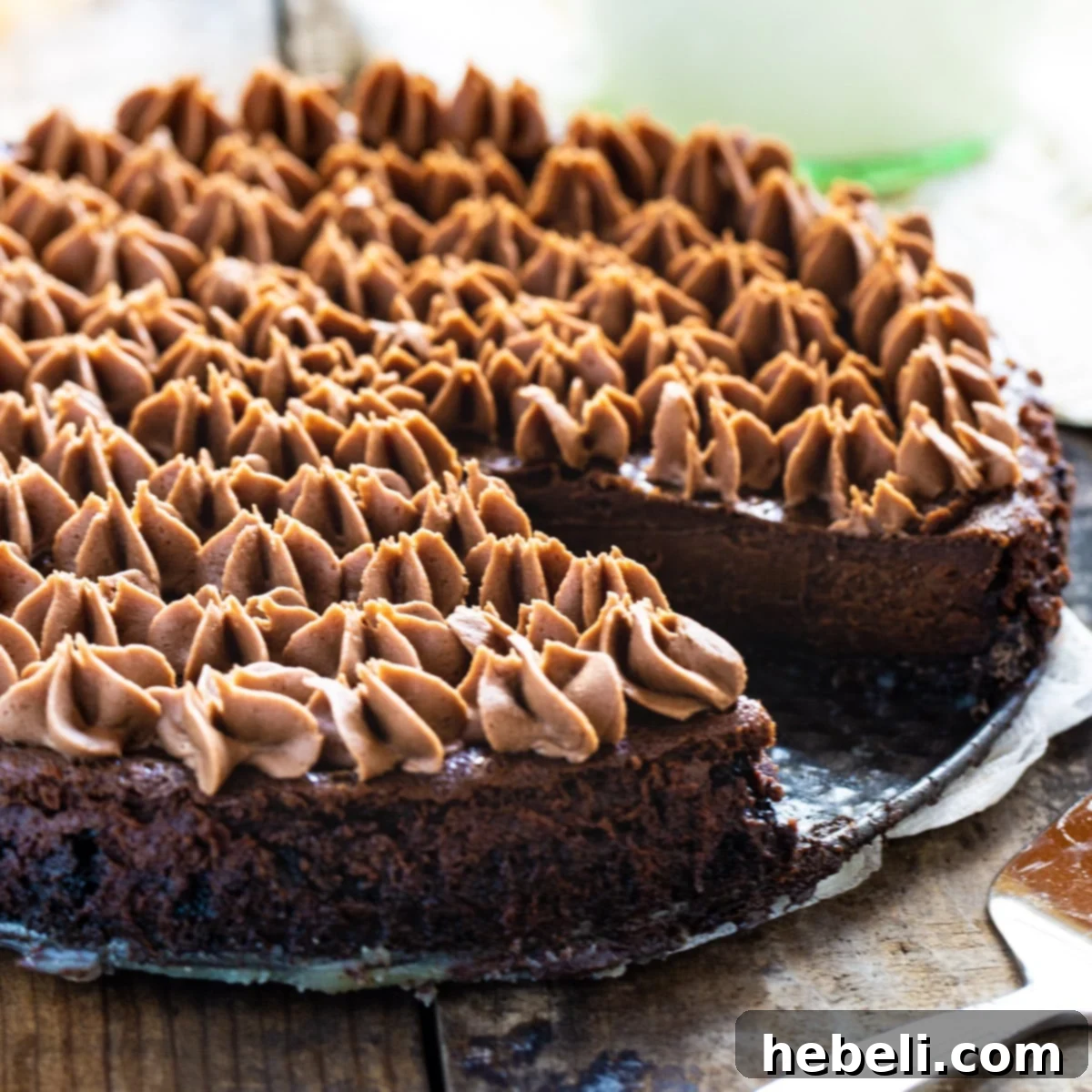 A stunning Chocolate Velvet Dessert, with a perfect slice cut out, showcasing its rich layers and creamy texture.