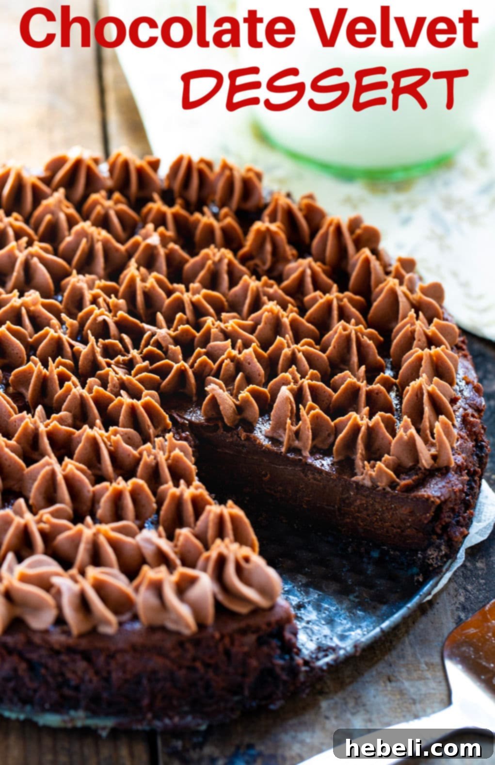 Close-up of Chocolate Velvet Dessert with a slice removed, highlighting the smooth chocolate filling and cookie crust.