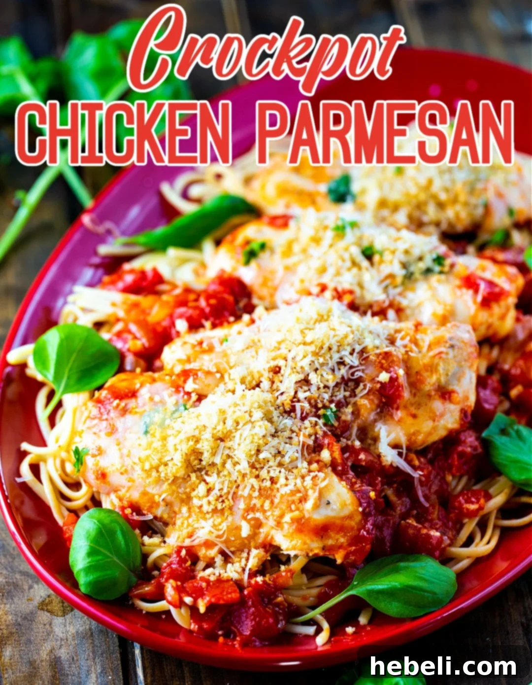 Close-up of Crock Pot Chicken Parmesan on a serving plate, showing melted cheese and crispy topping.