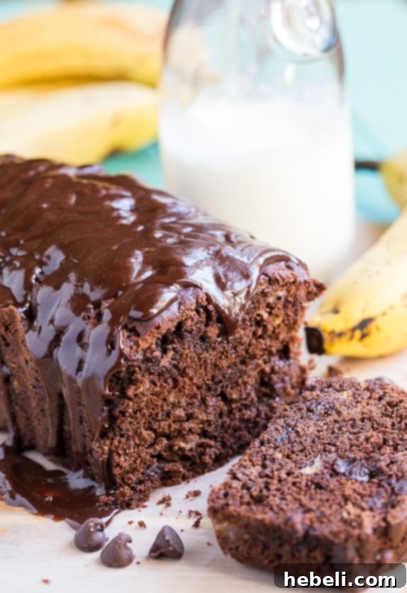 Decadent Triple Chocolate Banana Loaf 3 A close-up of a rustic loaf of Triple Chocolate Banana Bread, highlighting its rich texture and visible chocolate chips, ready to be sliced.