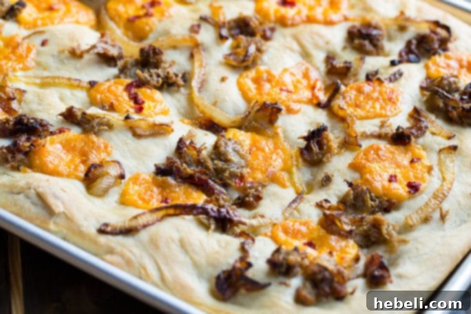 Southern Comfort Focaccia 3 Southern-Style Focaccia with pulled pork, pimento cheese, and vidalia onions.