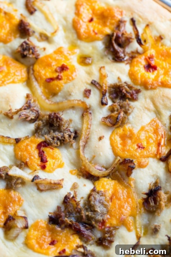 Southern Comfort Focaccia 6 Southern-Style Focaccia with pulled pork, pimento cheese, and vidalia onion.