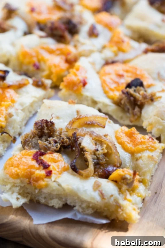 Southern Comfort Focaccia 7 Southern-Style Focaccia with pulled pork, pimento cheese, and vidalia onion.