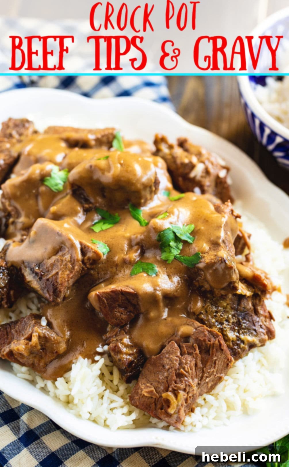 Close-up of Crock Pot Beef Tips and Gravy served over white rice on a white plate, ready to eat.