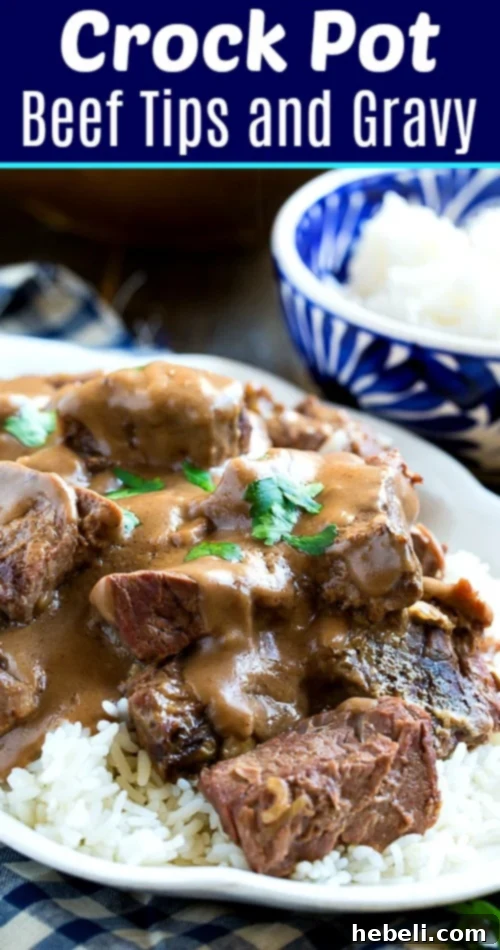 Close-up of Slow Cooker Beef Tips and Gravy with rice, on a rustic wooden background.