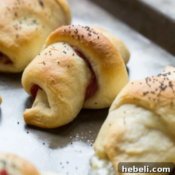 Stuffed Reuben Crescents 2 Reuben Crescent Rolls - golden-brown crescent rolls stuffed with corned beef, swiss cheese, kraut, and thousand island dressing, served as an appetizer.