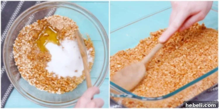 A cook's hands pressing the crushed pretzel mixture into a rectangular baking pan for the crust layer of Strawberry Pretzel Salad.