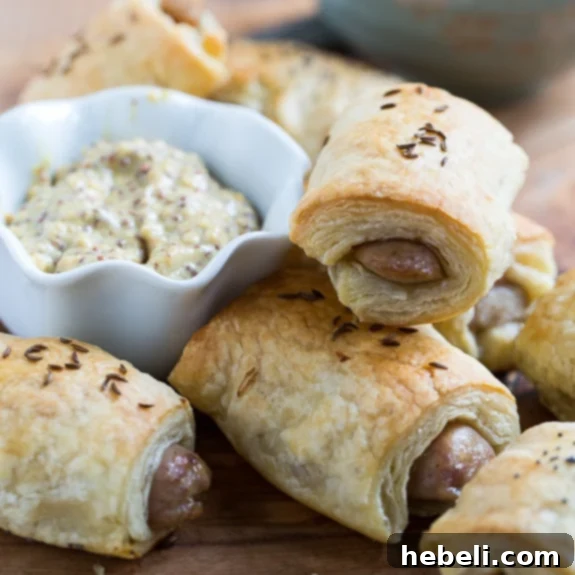 German-Style Pigs in a Blanket arranged on a serving platter with a side of mustard