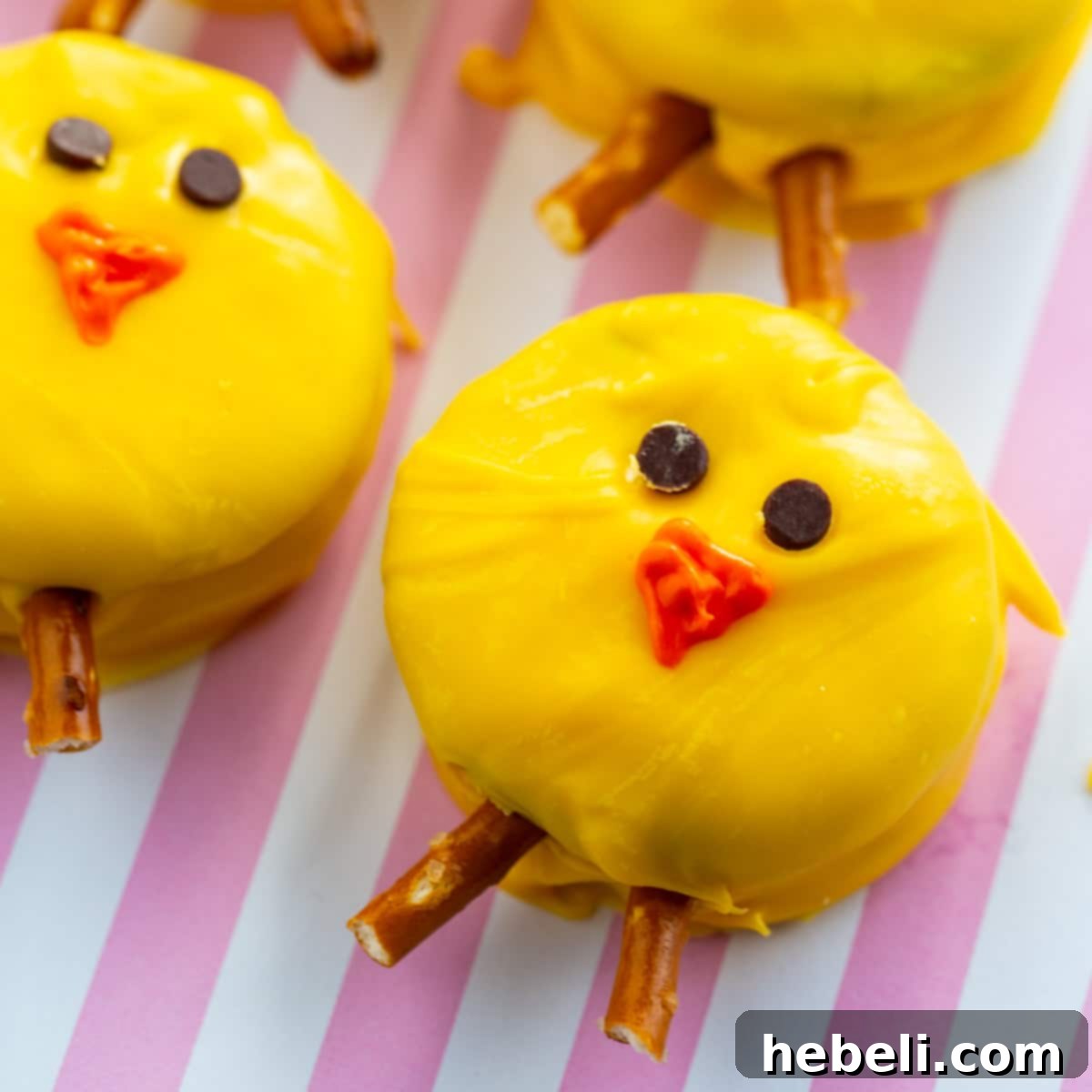 Hoppy Oreo Chicks 2 Adorable Oreo Easter Chicks arranged on a charming pink and white striped background, ready for spring celebrations.