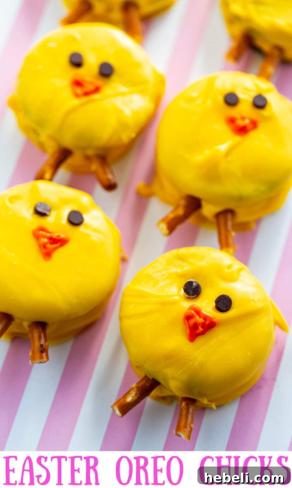 Hoppy Oreo Chicks 5 A cluster of freshly made Oreo Easter Chicks with bright yellow coating, mini chocolate chip eyes, and pretzel stick legs, presented on a festive pink and white background, highlighting their adorable details.