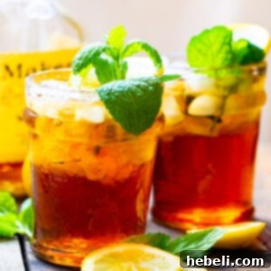 Two Sweet Tea Mint Juleps with mint sprigs, visually representing the finished cocktail.