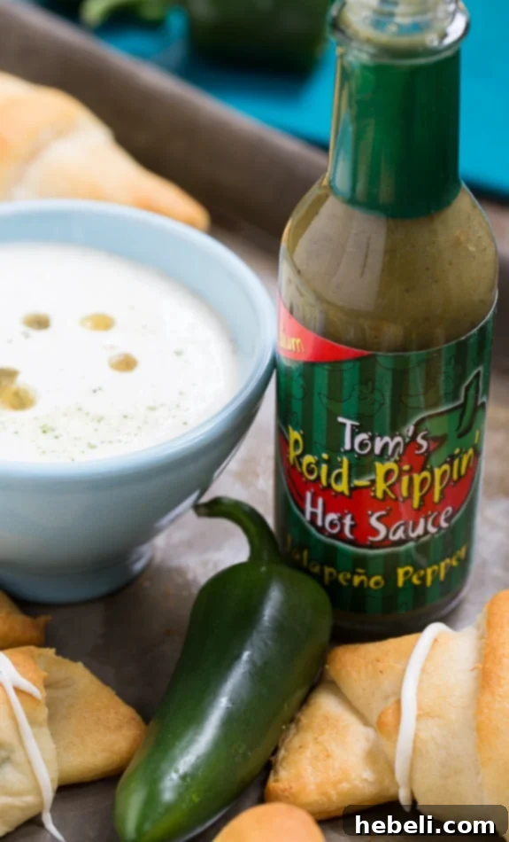 Cheesy Jalapeno Popper Crescent Rolls 7 Jalapeno Popper Crescent Rolls with a side of homemade Spicy Ranch dipping sauce, perfect for a party appetizer or game day snack.