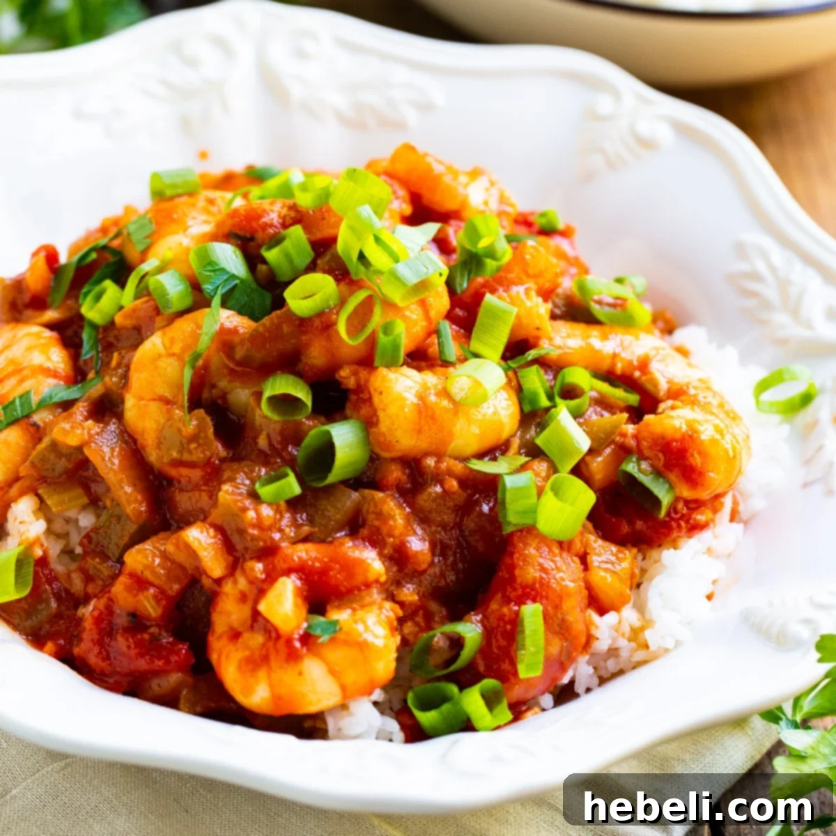 No-Fuss Shrimp Creole 2 Easy Shrimp Creole over rice in a bowl, garnished with fresh herbs.