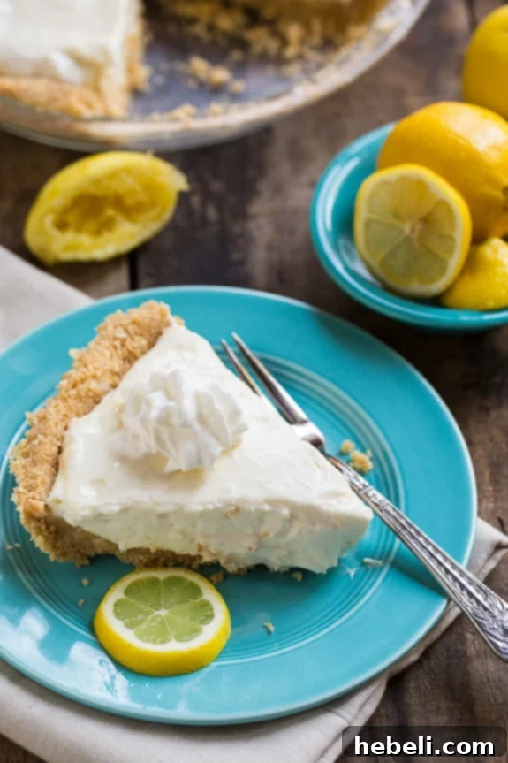 Creamy lemon filling being poured into the chilled shortbread crust for No-Bake Lemon Icebox Pie